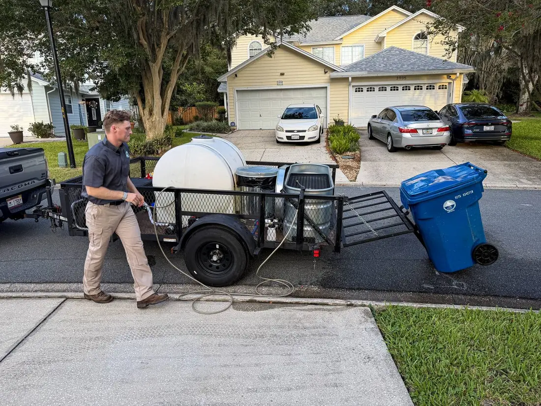 Hill Bros Bin Cleaning crew member servicing a trash bin with the rig